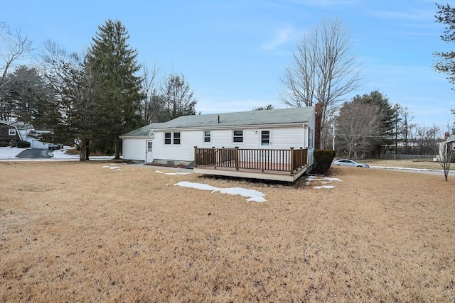 back of house with a lawn and a deck