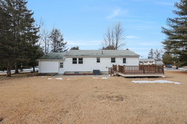 back of house with central AC, a yard, and a deck