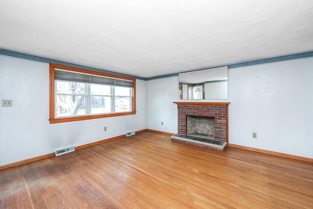 unfurnished living room featuring a fireplace and wood-type flooring