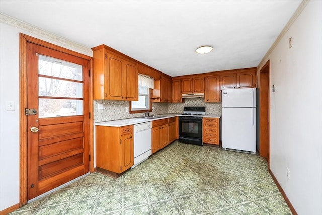 kitchen with backsplash, white appliances, and sink