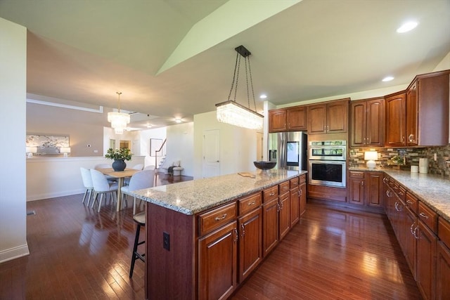3 Lexington Dr, Walpole, MA 02032 - kitchen featuring appliances with stainless steel finishes, dark wood-style floors, a center island, a breakfast bar area, and lofted ceiling