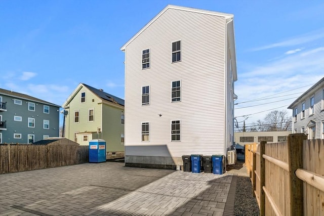 rear view of property featuring fence private yard and a patio area