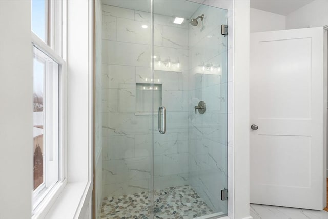 full bath featuring marble finish floor and a stall shower