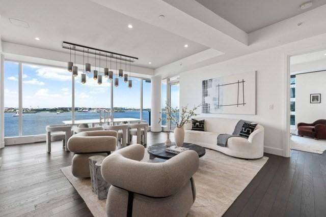 living room featuring a water view and light hardwood / wood-style floors