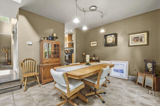 dining space featuring light tile patterned flooring