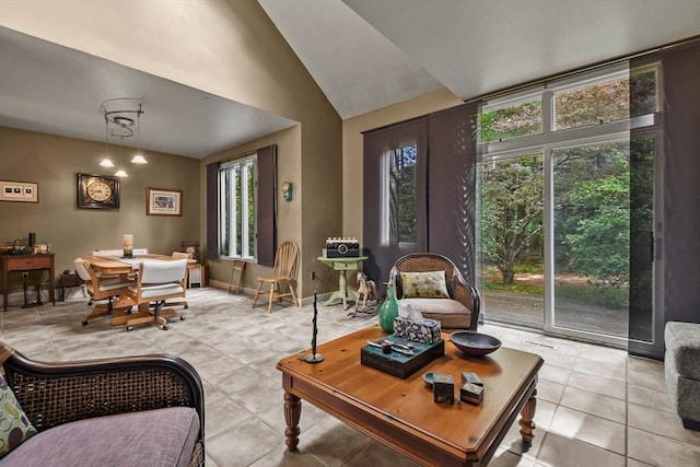 living room with lofted ceiling and light tile patterned flooring