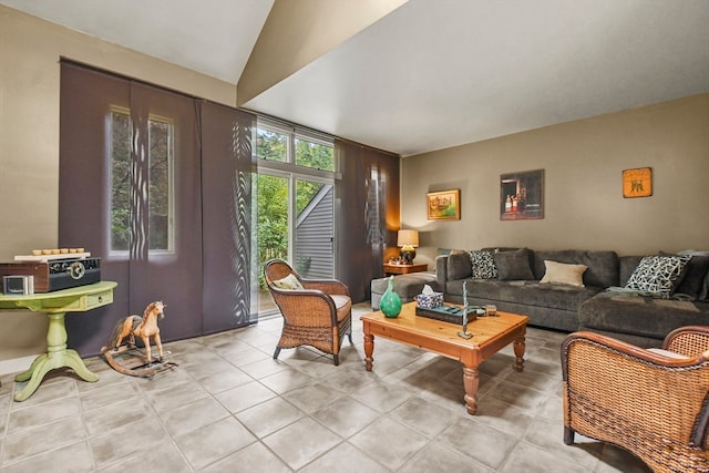 living room featuring lofted ceiling and light tile patterned floors