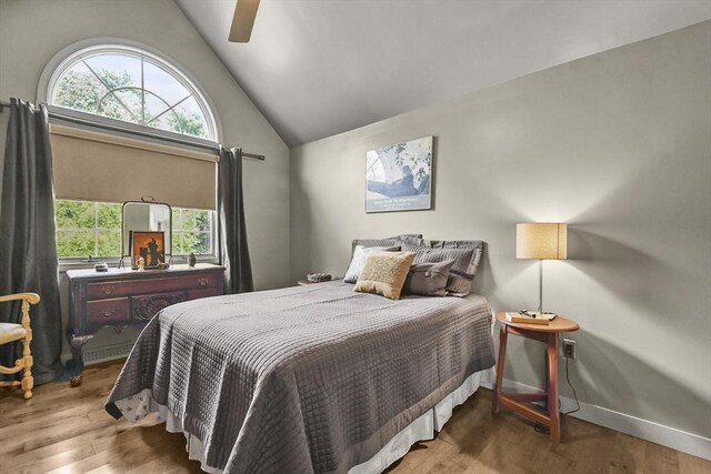 bedroom featuring ceiling fan, vaulted ceiling, and wood-type flooring