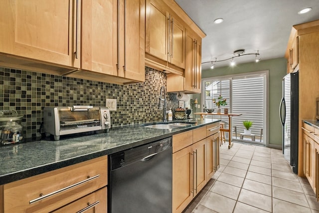 kitchen with decorative backsplash, dark stone countertops, light tile patterned flooring, black appliances, and sink