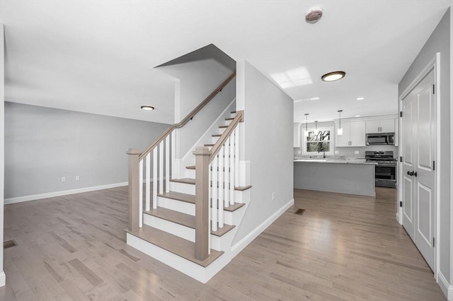 stairway featuring hardwood / wood-style flooring