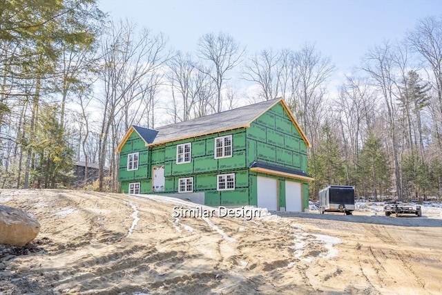 property in mid-construction with an attached garage and driveway