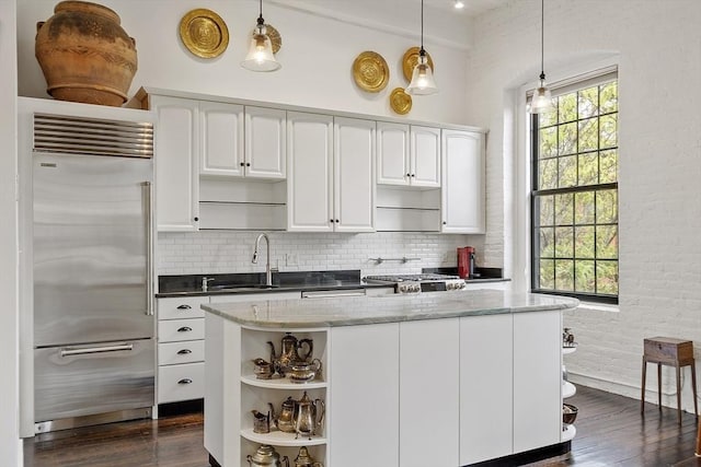 150 Moody St Unit 34, Waltham, MA 02453 - kitchen featuring stainless steel built in fridge, a sink, open shelves, dark wood finished floors, and decorative backsplash