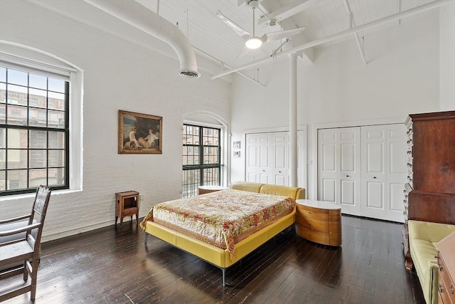 150 Moody St Unit 34, Waltham, MA 02453 - bedroom featuring a high ceiling, two closets, wood-type flooring, beam ceiling, and ceiling fan