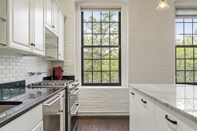 150 Moody St Unit 34, Waltham, MA 02453 - kitchen with double oven range, decorative backsplash, dark wood-type flooring, and healthy amount of natural light