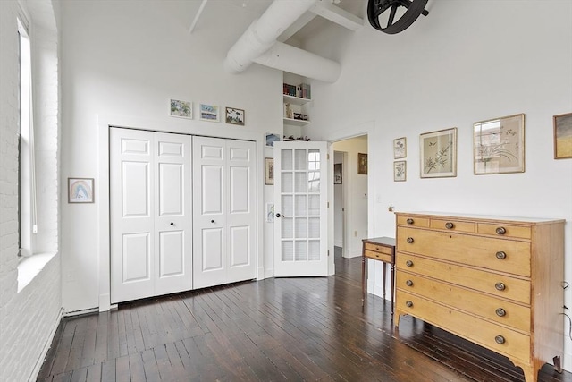 150 Moody St Unit 34, Waltham, MA 02453 - bedroom featuring dark wood-style flooring, a towering ceiling, and a closet