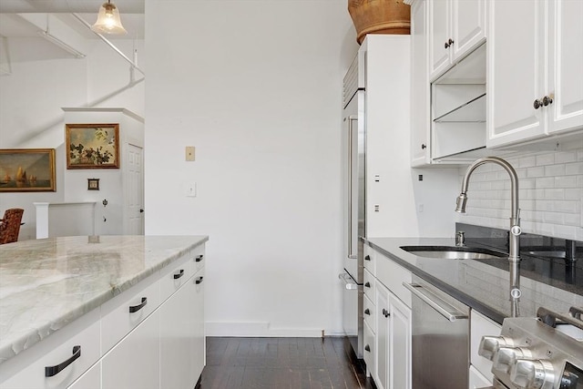 150 Moody St Unit 34, Waltham, MA 02453 - kitchen featuring stainless steel dishwasher, tasteful backsplash, light stone counters, a sink, and white cabinets