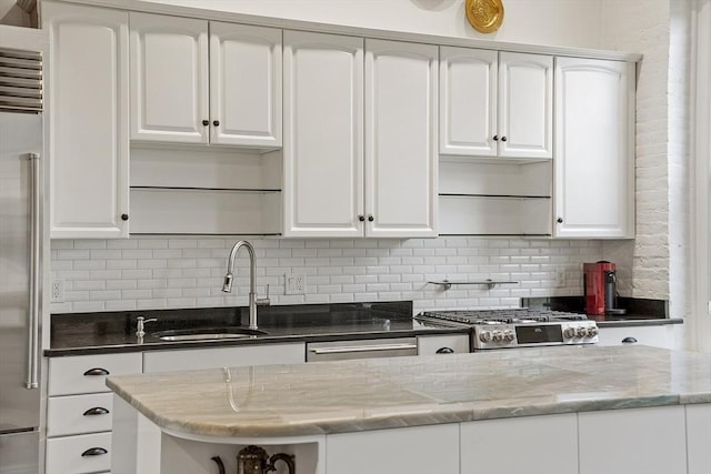 150 Moody St Unit 34, Waltham, MA 02453 - kitchen featuring a sink, appliances with stainless steel finishes, backsplash, and white cabinetry