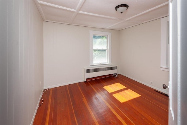 unfurnished room with radiator, baseboards, and hardwood / wood-style flooring