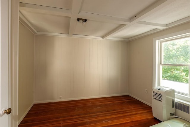 unfurnished room with baseboards, radiator, wood finished floors, and coffered ceiling