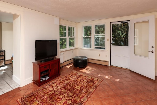 tiled living room featuring a textured ceiling, a baseboard heating unit, and baseboards