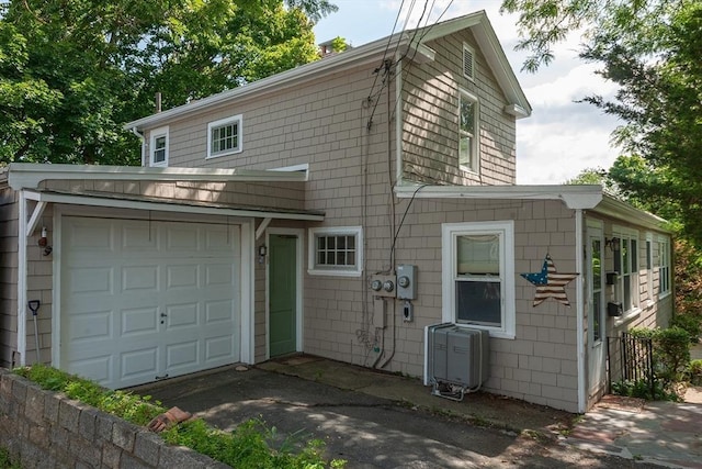 view of front of house with aphalt driveway and a garage