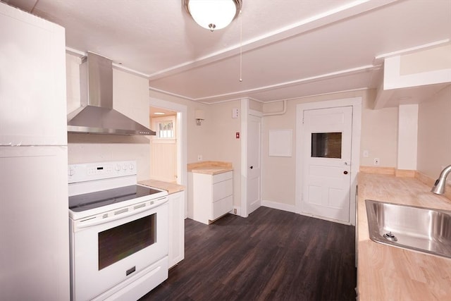 kitchen featuring wall chimney range hood, electric stove, dark wood-style floors, white cabinetry, and a sink