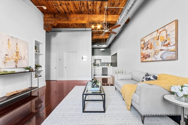 37 Millyard Unit 206, Amesbury, MA 01913 - living room featuring wood finished floors, a high ceiling, wooden ceiling, beam ceiling, and built in features