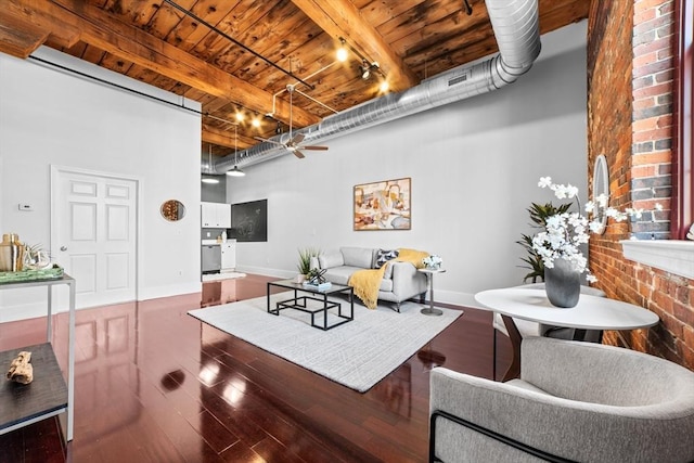 37 Millyard Unit 206, Amesbury, MA 01913 - living room featuring wooden ceiling, rail lighting, beam ceiling, wood finished floors, and baseboards