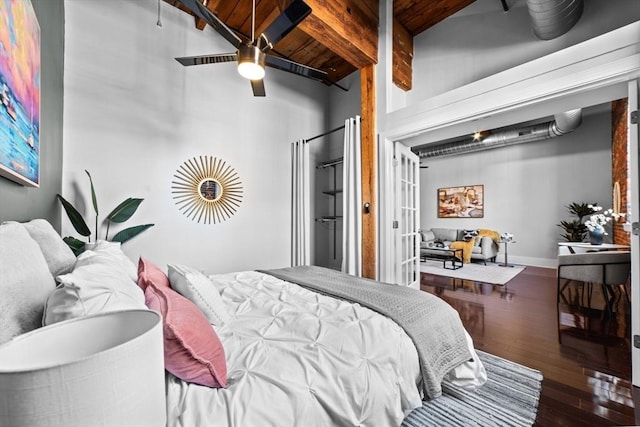 37 Millyard Unit 206, Amesbury, MA 01913 - bedroom featuring a high ceiling, beamed ceiling, wood finished floors, wood ceiling, and french doors