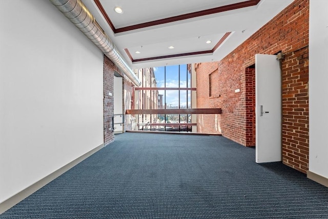 37 Millyard Unit 206, Amesbury, MA 01913 - carpeted spare room featuring brick wall, ornamental molding, a towering ceiling, and expansive windows