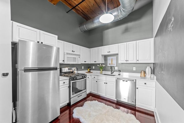 37 Millyard Unit 206, Amesbury, MA 01913 - kitchen with stainless steel appliances, a towering ceiling, a sink, wood ceiling, and light countertops