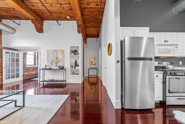 37 Millyard Unit 206, Amesbury, MA 01913 - kitchen with stainless steel appliances, wood ceiling, beam ceiling, white cabinets, and a towering ceiling