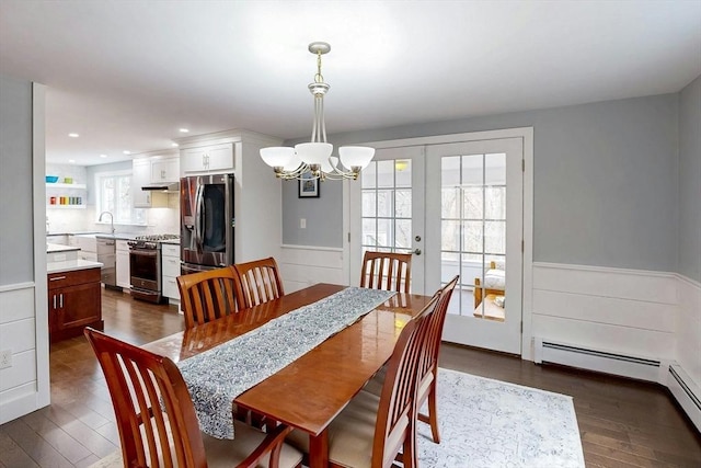 dining room with french doors, dark wood-style flooring, wainscoting, a notable chandelier, and recessed lighting