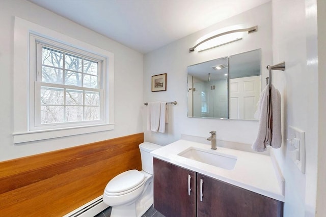 bathroom with vanity, toilet, walk in shower, and a baseboard radiator