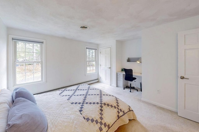 bedroom with carpet flooring, baseboards, visible vents, and baseboard heating