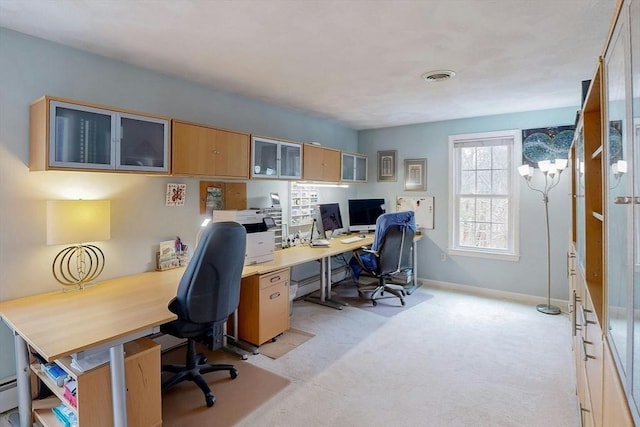 office space featuring baseboards, visible vents, and light carpet