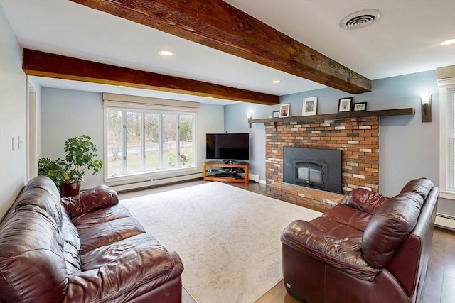 living area featuring baseboard heating, recessed lighting, wood finished floors, and visible vents