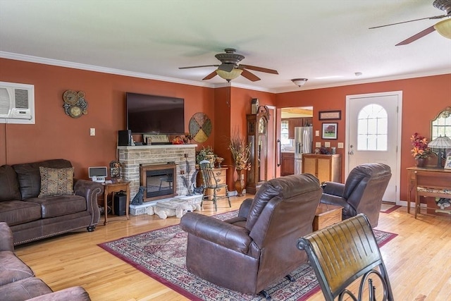 224 Palmer Rd, Monson, MA 01057 - living room featuring ceiling fan, wood finished floors, crown molding, a wall mounted AC, and a stone fireplace