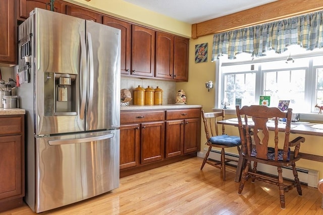 224 Palmer Rd, Monson, MA 01057 - kitchen with stainless steel refrigerator with ice dispenser, light countertops, light wood-style floors, a baseboard heating unit, and tasteful backsplash