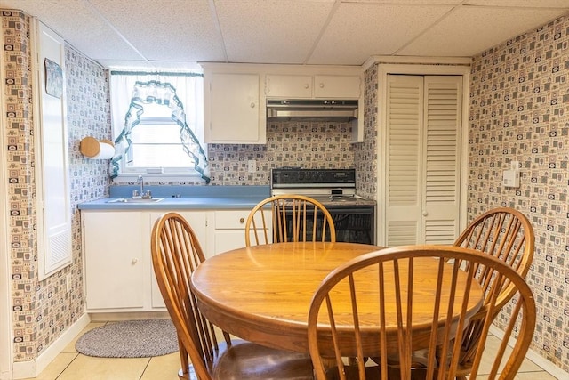 224 Palmer Rd, Monson, MA 01057 - kitchen featuring under cabinet range hood, black electric range oven, a sink, a paneled ceiling, and light tile patterned floors