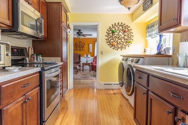 224 Palmer Rd, Monson, MA 01057 - kitchen featuring stainless steel appliances, washing machine and dryer, light wood finished floors, ceiling fan, and light countertops
