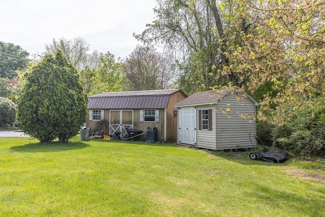 224 Palmer Rd, Monson, MA 01057 - back of house featuring a storage unit, a yard, metal roof, central air condition unit, and an outbuilding