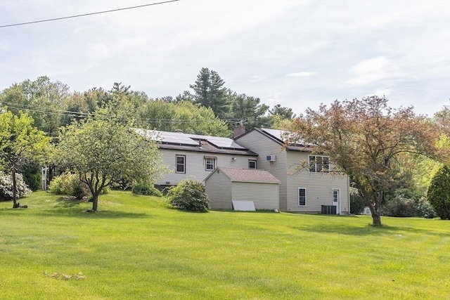 224 Palmer Rd, Monson, MA 01057 - back of house with a lawn, central AC unit, and solar panels