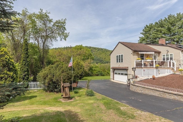 224 Palmer Rd, Monson, MA 01057 - view of front of property with asphalt driveway, an attached garage, a chimney, and a deck