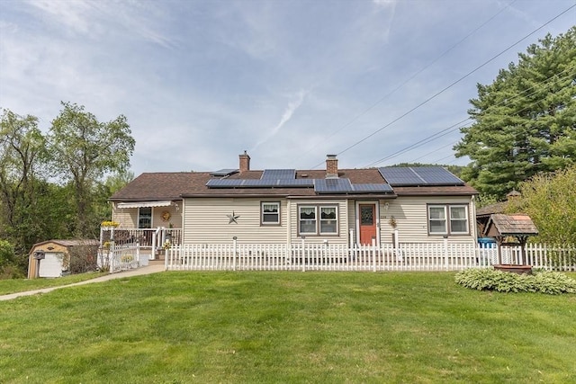 224 Palmer Rd, Monson, MA 01057 - view of front facade featuring solar panels, an outbuilding, a chimney, and a storage unit