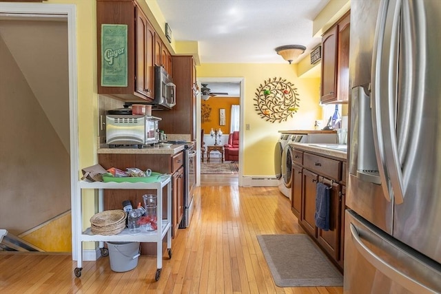 224 Palmer Rd, Monson, MA 01057 - kitchen with stainless steel appliances, independent washer and dryer, light wood-style flooring, baseboards, and light countertops