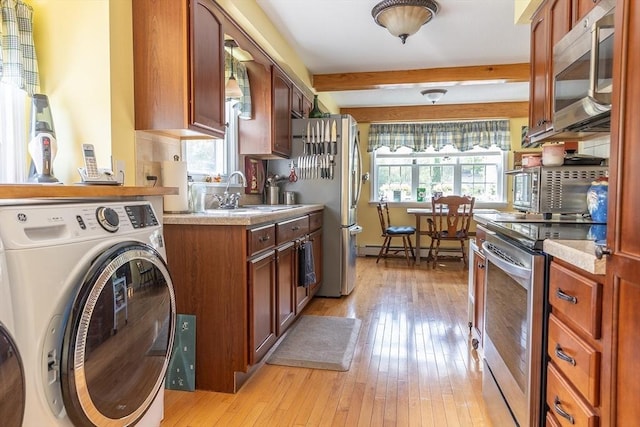 224 Palmer Rd, Monson, MA 01057 - kitchen with washer / dryer, a sink, appliances with stainless steel finishes, light wood-style flooring, and beamed ceiling