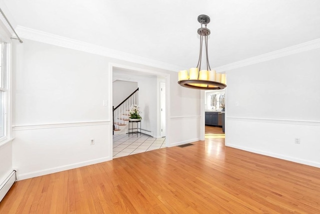 interior space featuring baseboard heating, light hardwood / wood-style floors, and crown molding