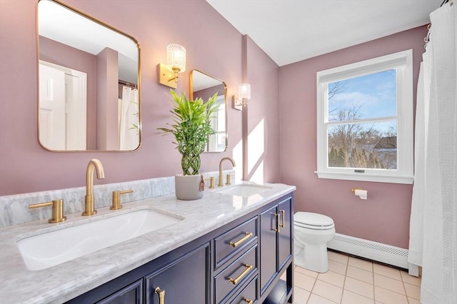 bathroom featuring tile patterned flooring, a baseboard radiator, vanity, and toilet