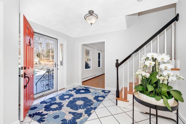 tiled foyer entrance with a baseboard radiator